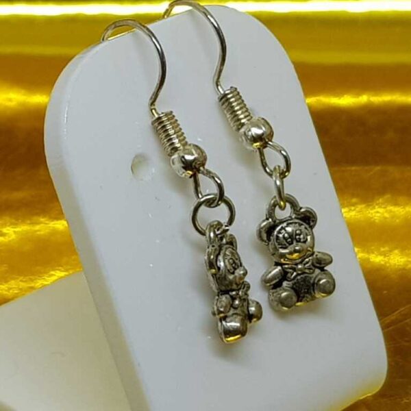 Hanging silver coloured teddy bear earrings on silver coloured posts - Image 2