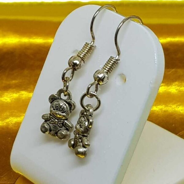 Hanging silver coloured teddy bear earrings on silver coloured posts - Image 3