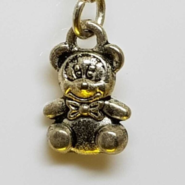 Hanging silver coloured teddy bear earrings on silver coloured posts - Image 4