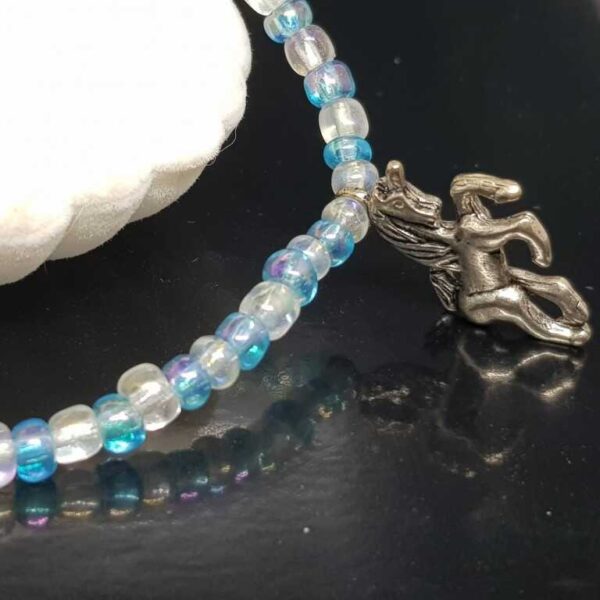 Bracelet with Small Baby Blue and White Beads with a Unicorn Pendant - Image 2