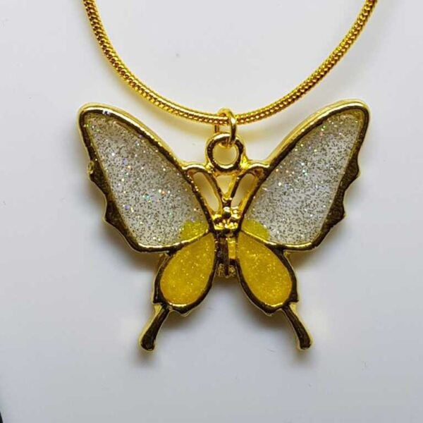 Gold coloured butterfly pendant with glittery yellow and silver coloured wings - Image 2