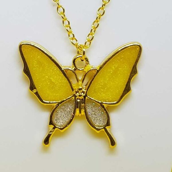 Gold coloured butterfly pendant with glittery yellow and silver wings on a gold coloured O link necklace. - Image 2