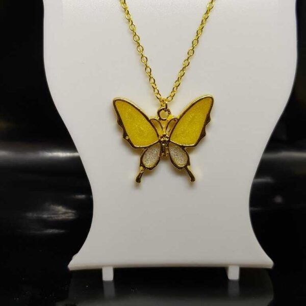 Gold coloured butterfly pendant with glittery yellow and silver wings on a gold coloured O link necklace.